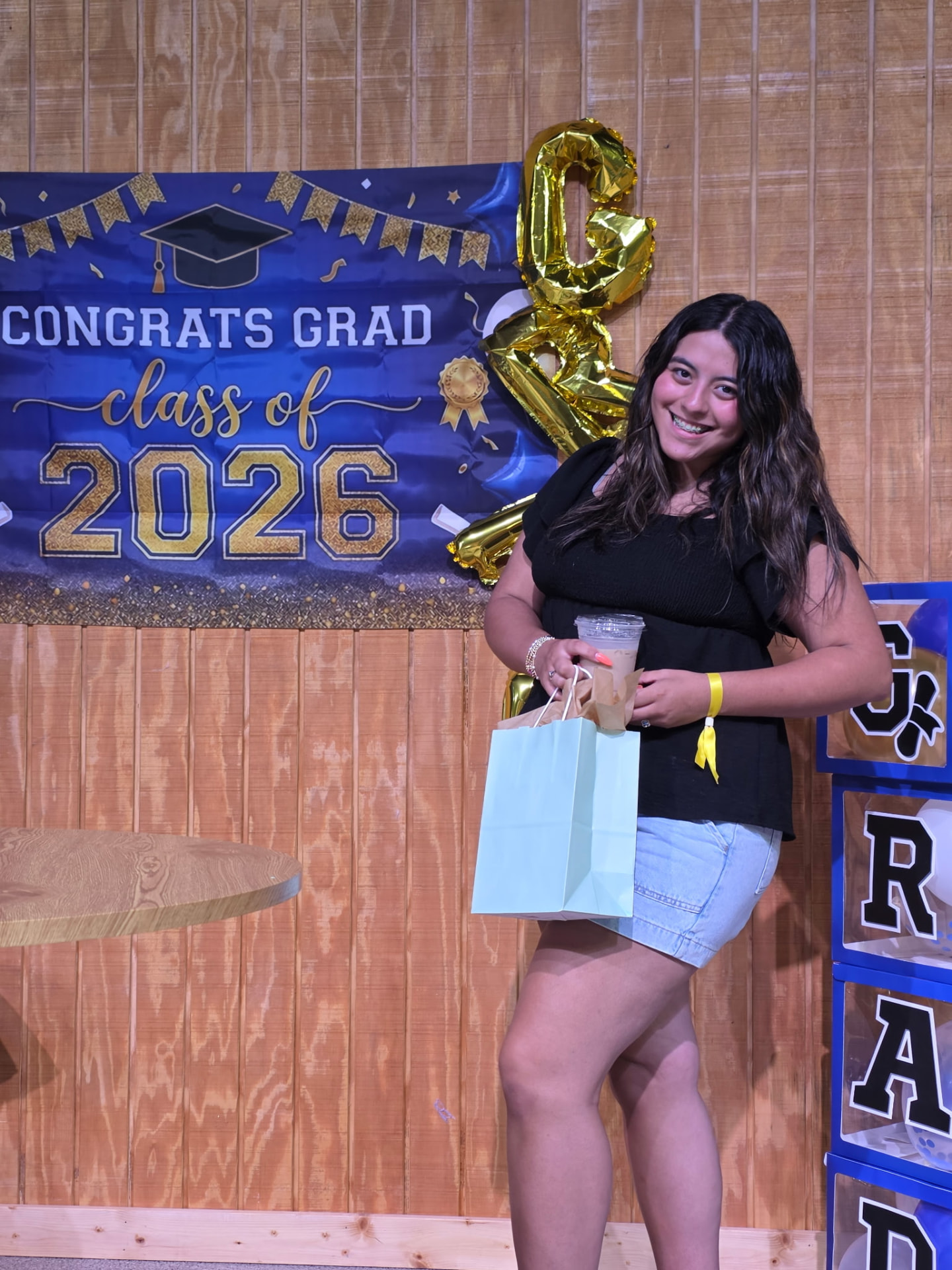 A graduating senior celebrating at the Class of 2026 graduate reception