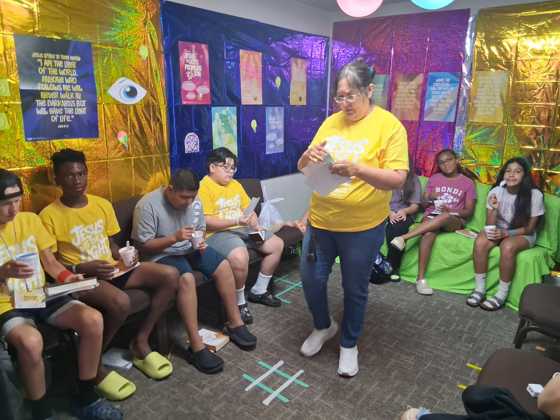Older kids gathered with a teacher for a Bible lesson and snacks