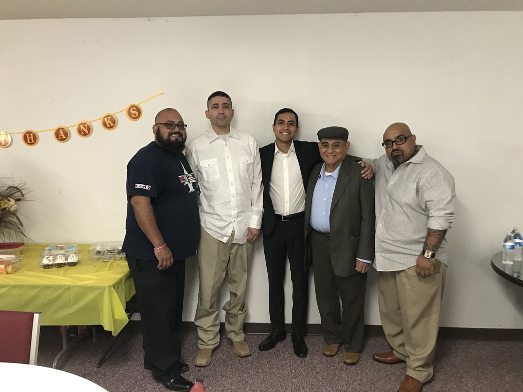 Men's group members posing together at a Thanksgiving fellowship meal