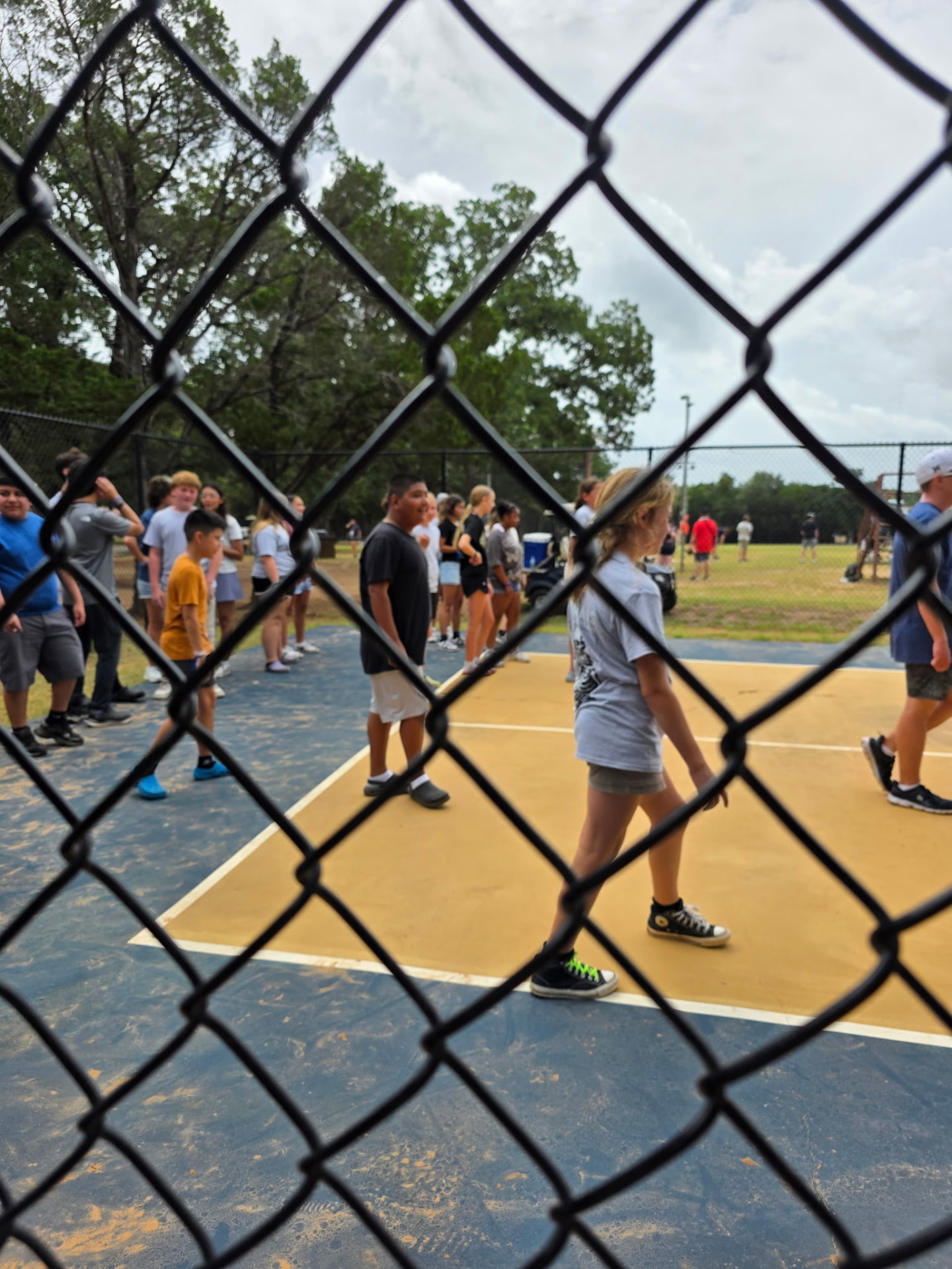 Students gathering on the outdoor court for a camp game