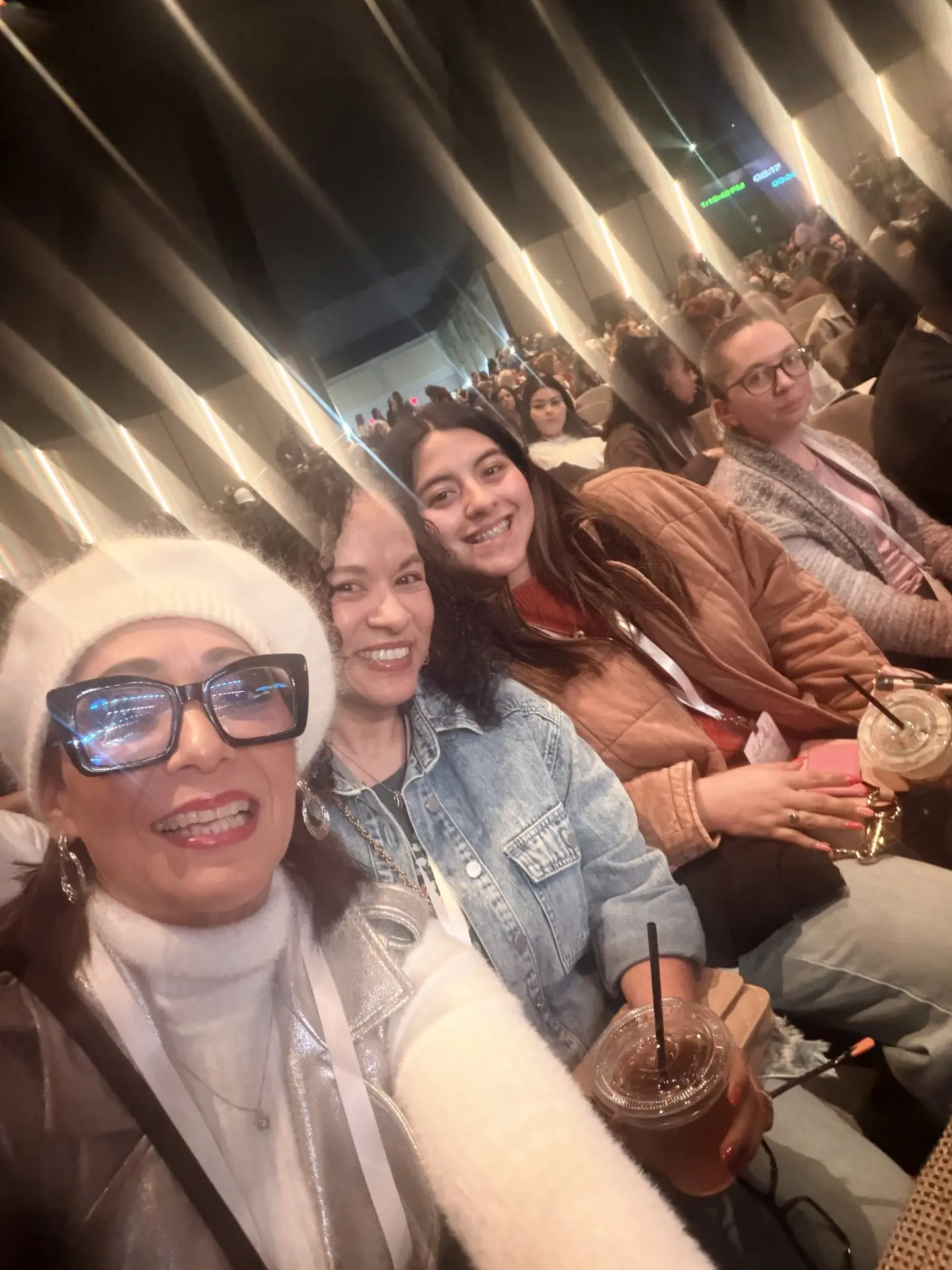 Three women from the church smiling at a conference session