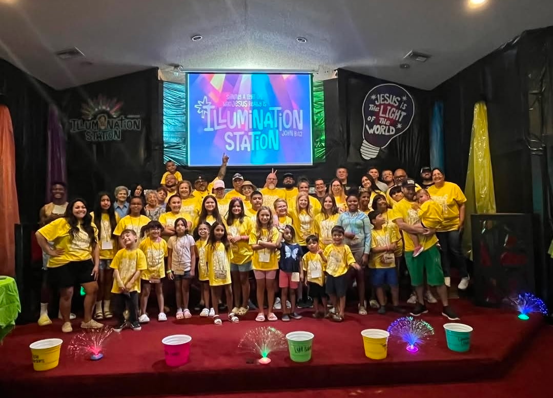 The whole Illumination Station Vacation Bible School group gathered on stage in yellow shirts