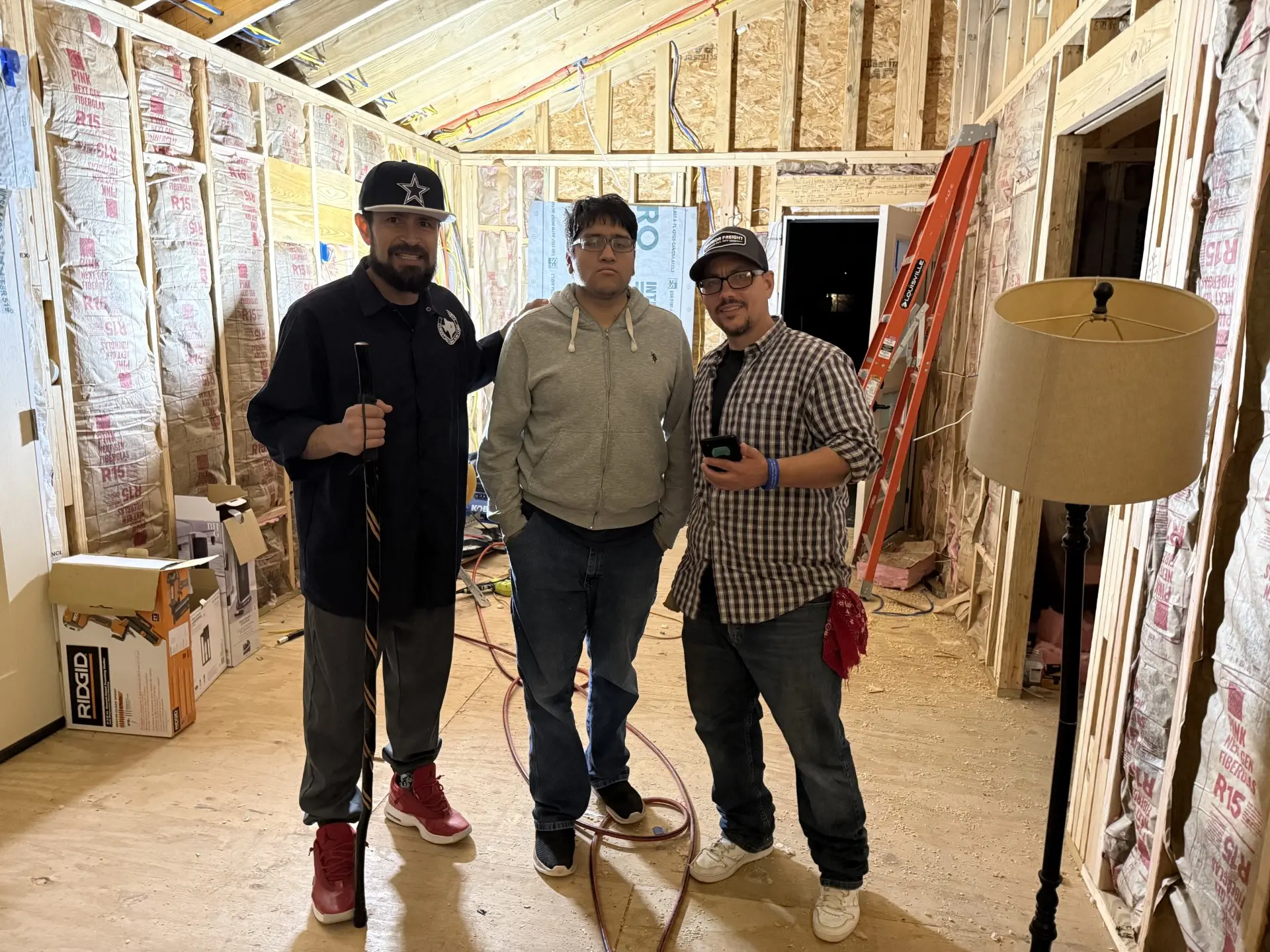 Three Job Corps men on a home construction job site
