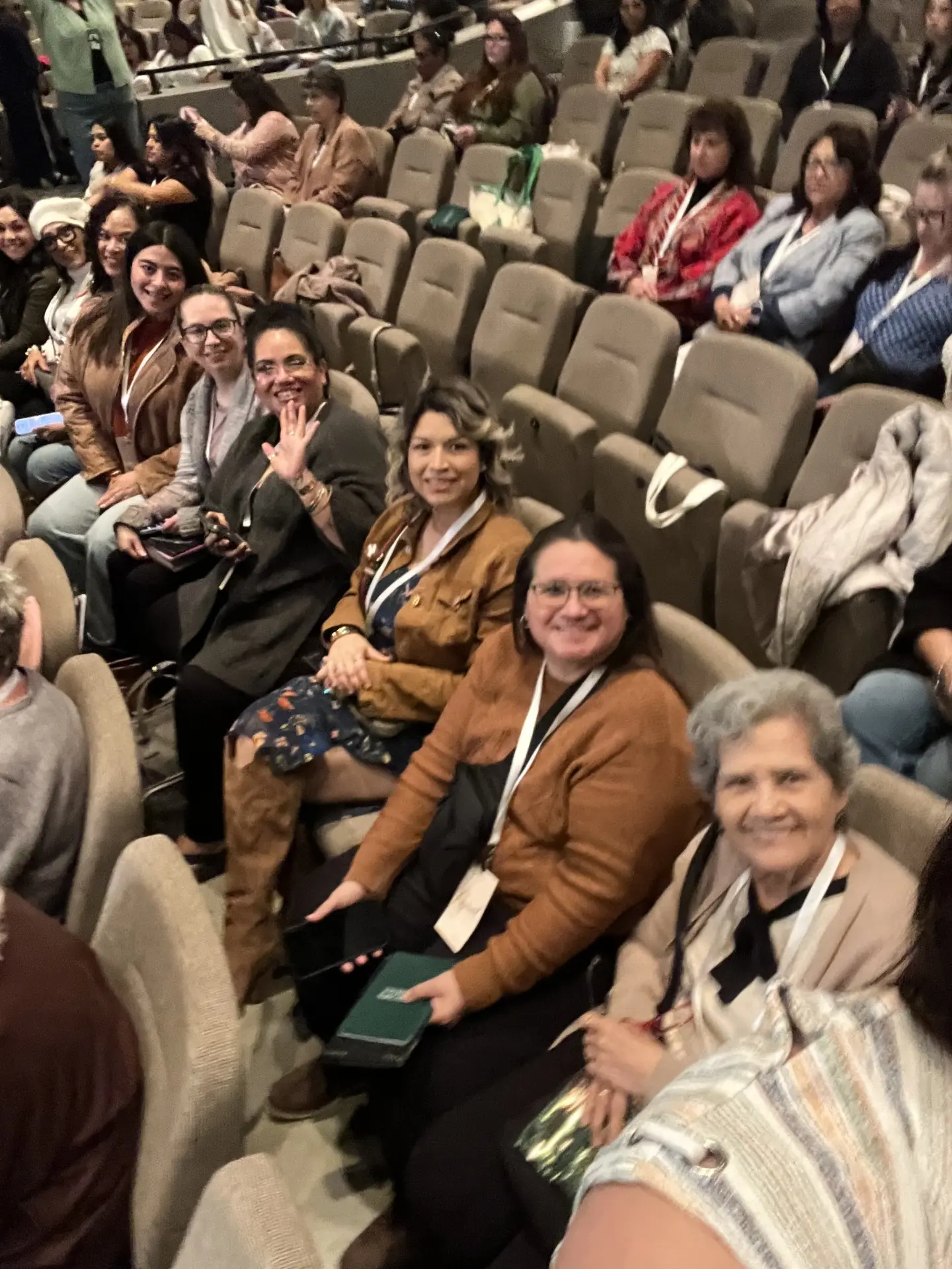 Women from the church seated together in the conference auditorium