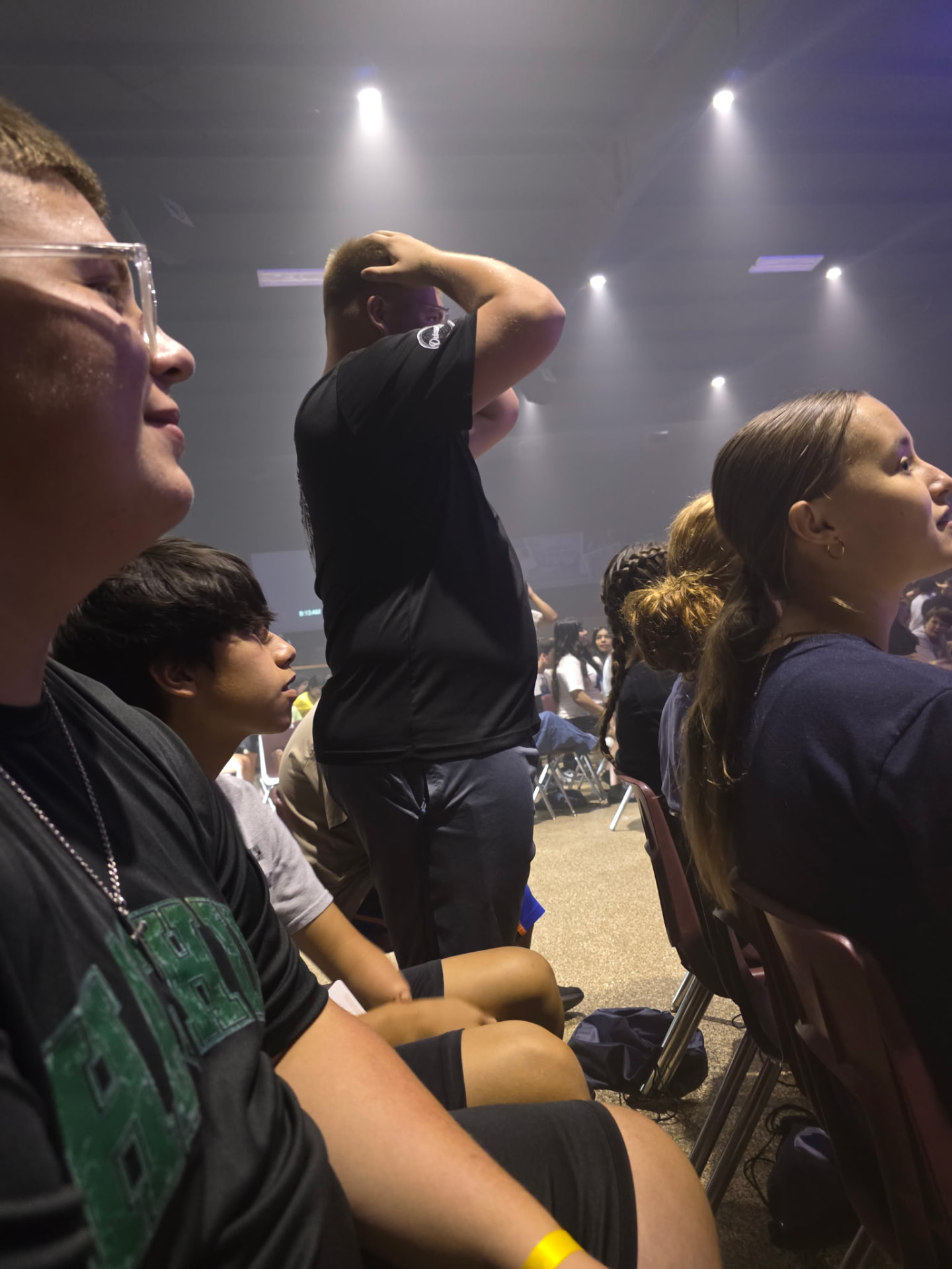 Students worshiping together during a camp evening session