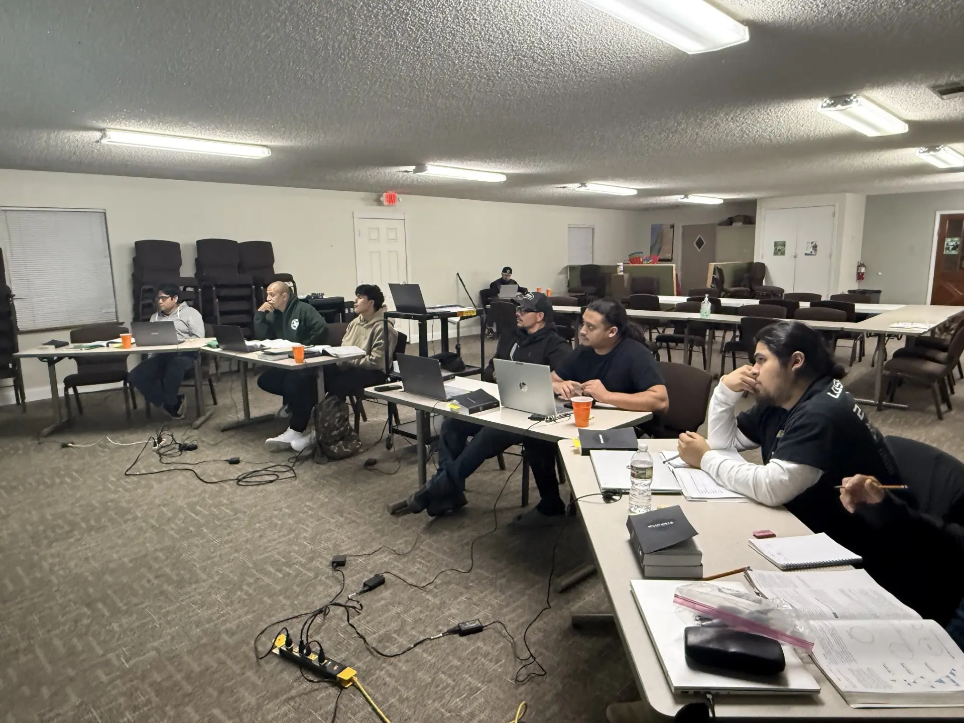 Job Corps students working on laptops during an evening class