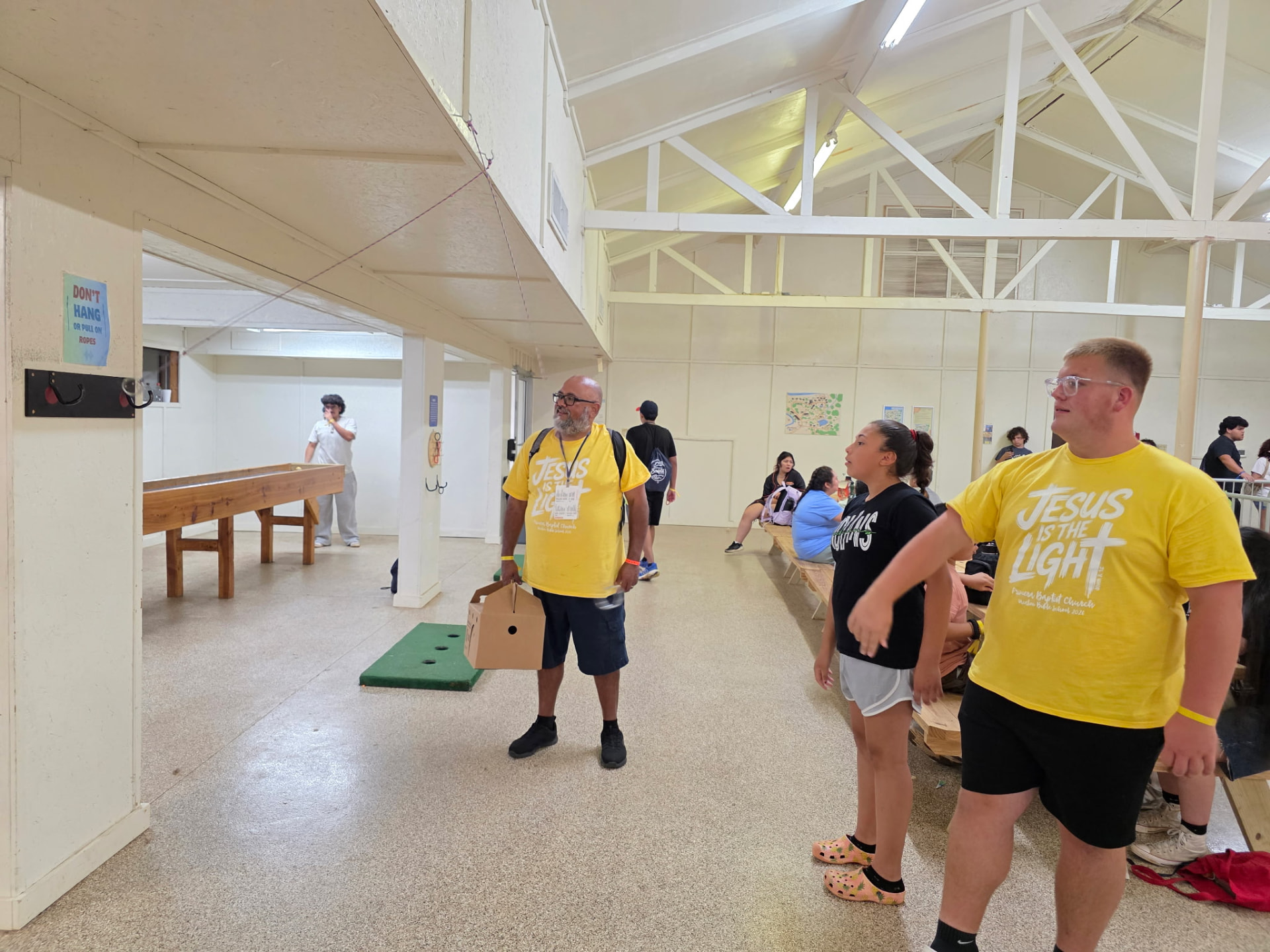 Students and leaders in Jesus is the Light shirts in the camp game room