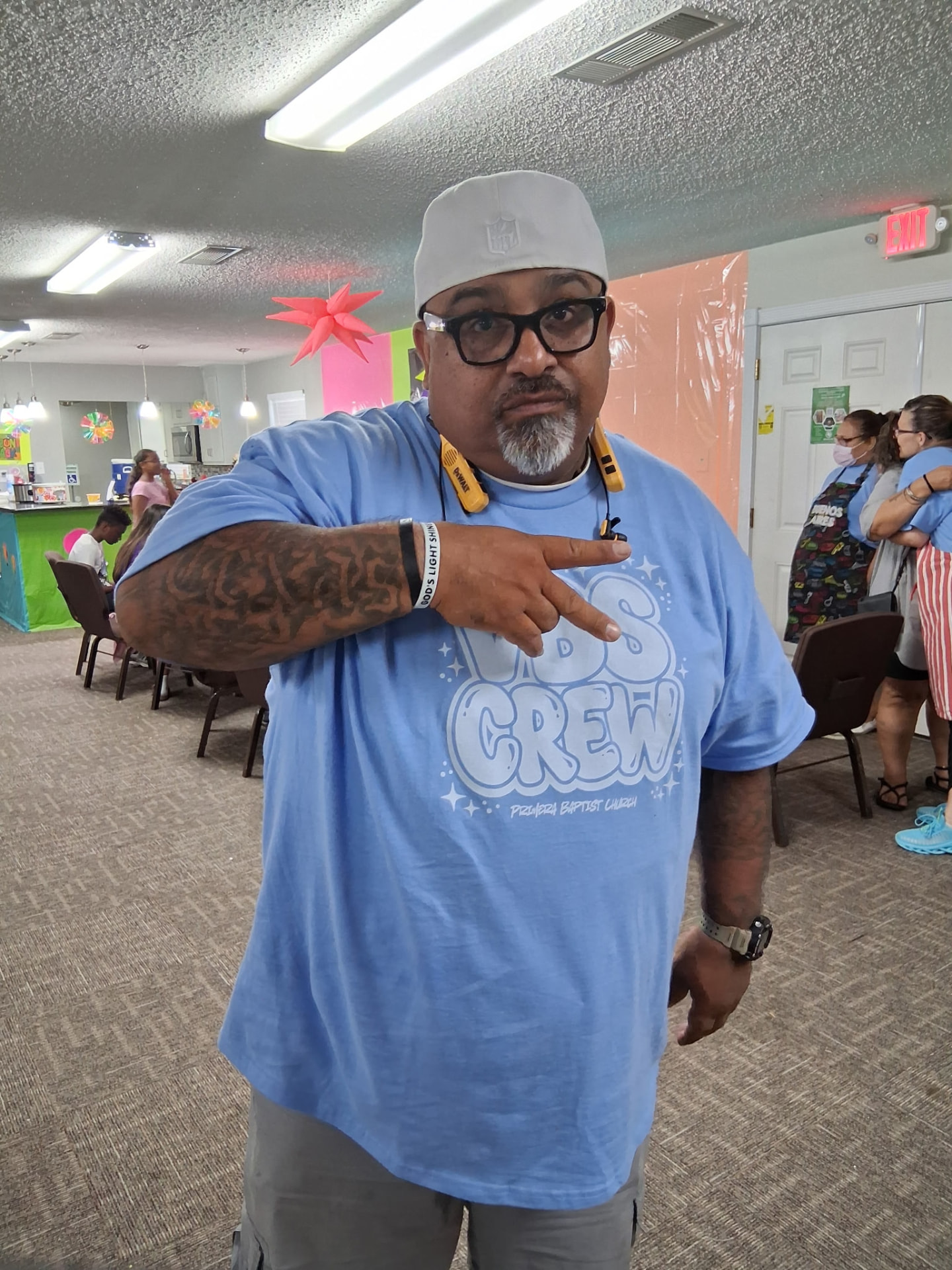 A VBS Crew volunteer smiling in the decorated fellowship hall